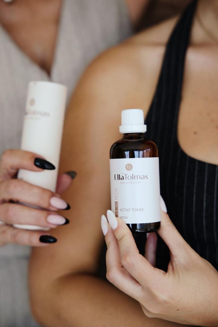 Ella Tolmas skincare bottles held in hand