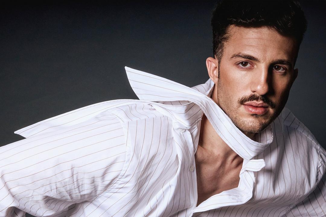 Tomer Tenenboym in a white striped shirt, collar in motion